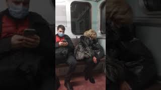 sleeping lady on the subway in a beautiful silver fox fur coat