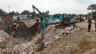 Rehabilitation of canals using many machines, Excavator Caterpillar 320B  KOBELCO Loading Trucks
