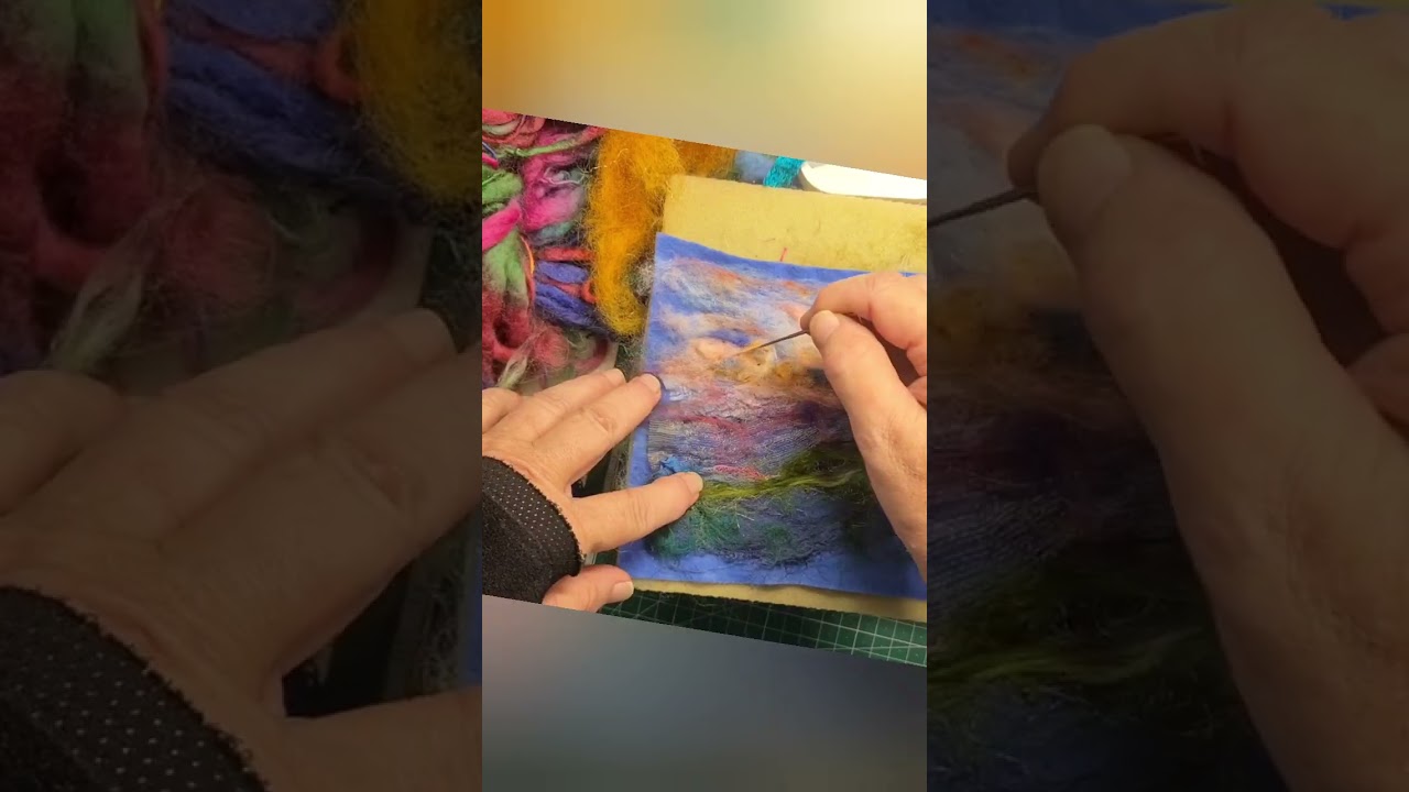 Needle felted landscape using wool roving snippets of fabric and novelty yarns.  