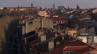 Historic urban landscape revealing Saint Sernin Basilica silhouette emerging from soft morning mist screenshot 5