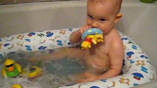 Emma blowing bubbles in the tub..