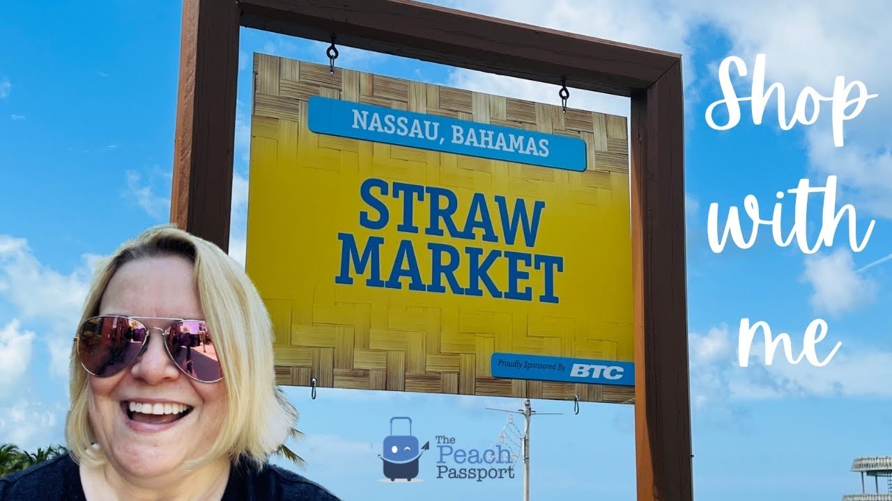 Straw bags embroidered with colorful flowers and other souvenirs on display  Nassau Bahamas - SuperStock