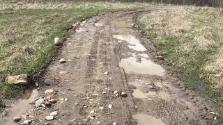 Using a compact tractor and box blade to grade and remove puddles