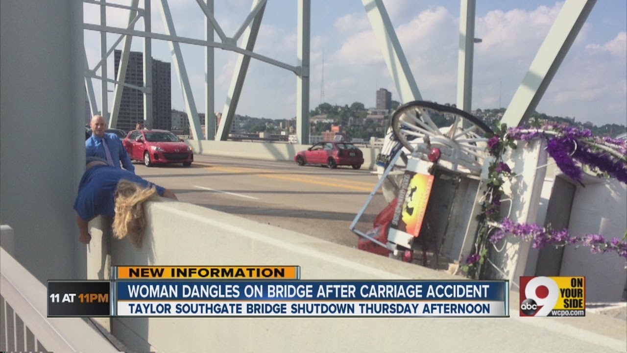 Woman dangles on bridge after carriage accident
