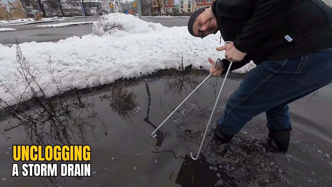 #066-2 Unclogging a storm drain on a parking lot after snowfall in ...