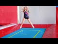 Little kid girl jumping on trampoline and bungee in a game center.