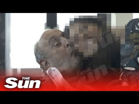 Sleazy Sir Philip Green caught on film kissing young worker