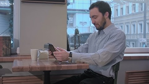 Yawns Young Man Using Tablet Computer In Cafe | Stock Footage - Videohive