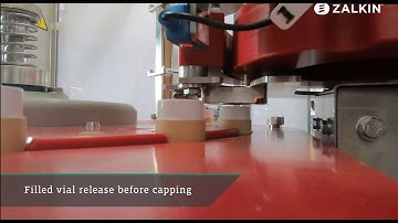 Zalkin push-on capper with filled vial release into cardboard canister