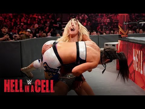 Charlotte Flair hits a fall-away slam on the ringside floor: WWE Hell in a Cell 2019