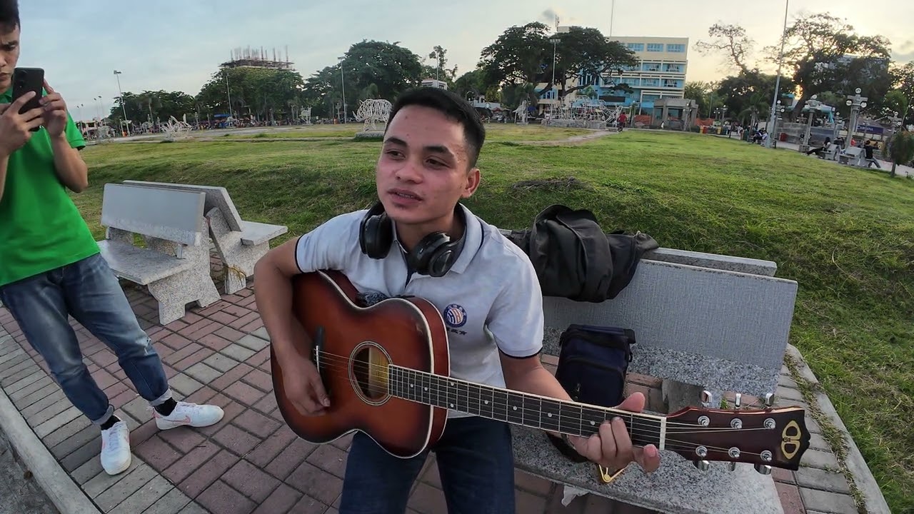 Play: Young Man Singing a Devotional Song on Jose Rizal Boulevard in Dumaguete, Philippines