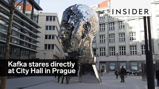 A sculpture of Franz Kafka's head faces City Hall in Prague