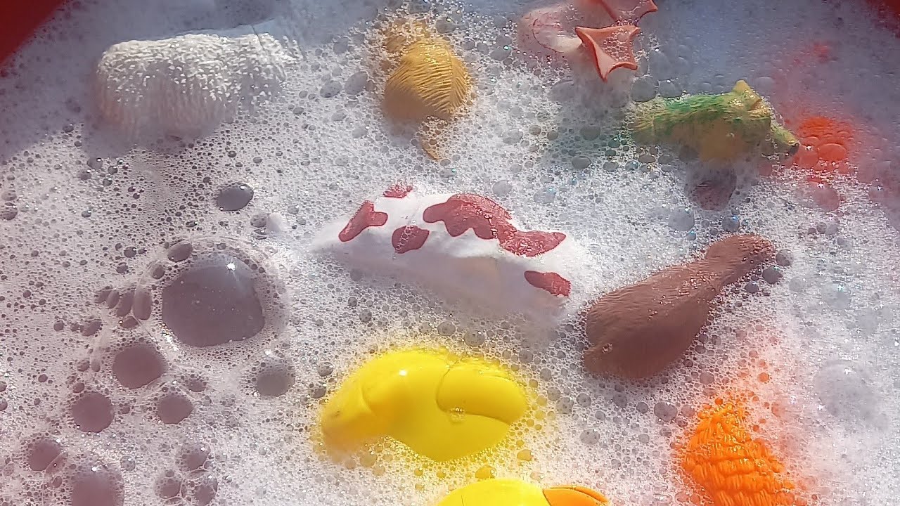 zoo animals toys being shown from red tub farm animals toys in red