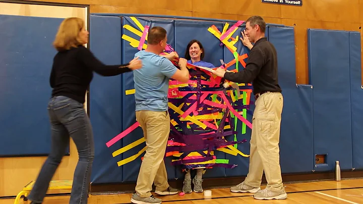 Principal Jill Flood gets taped to the wall in the...
