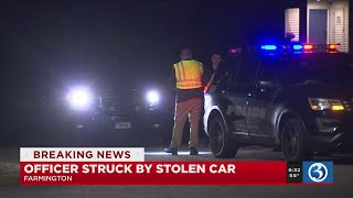 VIDEO: Police officer struck by driver of stolen car; officers search for suspects