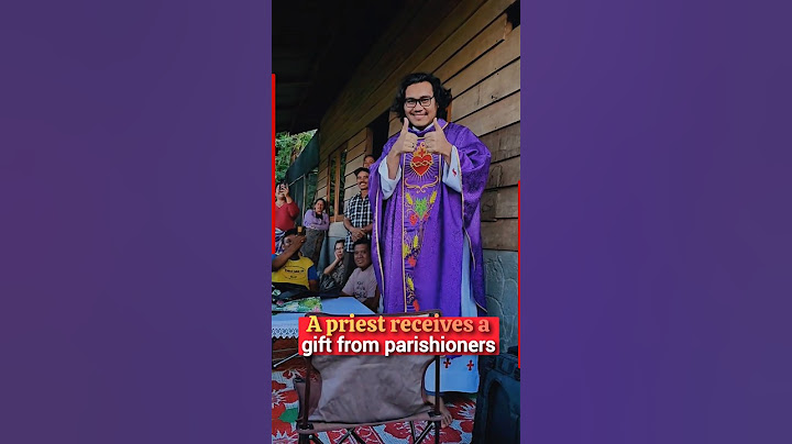 A priest joyfully receives a heartfelt gift from parishioners after celebrating outdoor Mass #priest