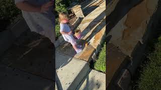 Little boy closes kitchen cabinet on his brother and bumps head