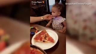 Chrissy teigen laughs as Luna gets served a HUGE slice of pizza