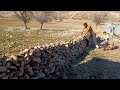 "Nomadic Family Bonds Through Stone Wall Construction"