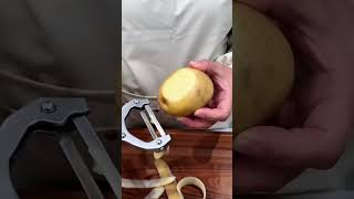 Blade glides clean—ginger ribbons fall in rhythmic grace