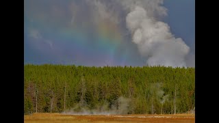 World&#39;s Tallest Geyser Erupts Amidst a Storm&#39;s Rainbow in Yellowstone Park, Steamboat Geyser