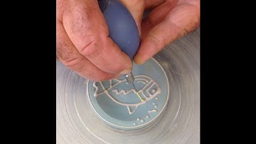 Slip trailing a fish on a little dish.