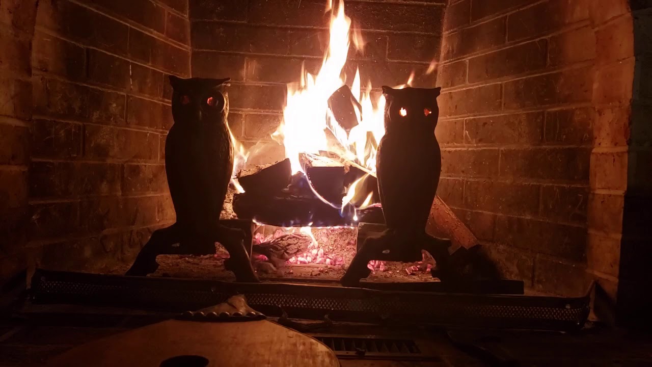 Fireplace with glowing orange owl eyes crackling fire relaxation