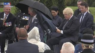 Boris Johnson struggles with umbrella at memorial for fallen police officers