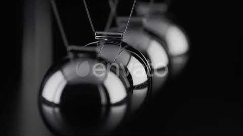 The balls of a Newtons Cradle colliding in slow motion | Stock Footage - Envato elements