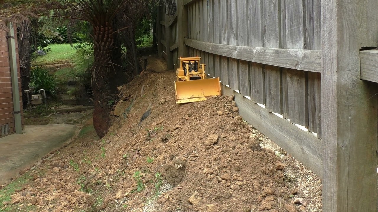 RC Dozer pushing dirt on dangerous road