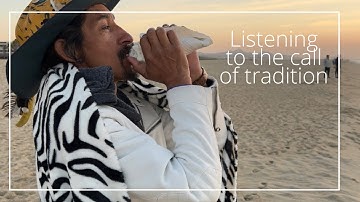 Native blows conch shell at Baja sunrise