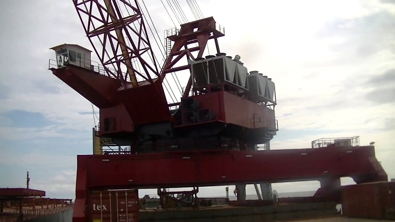 TDC 7040 crane transloading barge to ship - YouTube