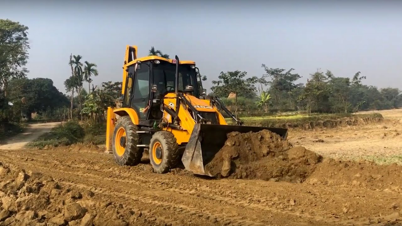 Soil & Village Road, JCB Backhoe 3DX Machine Mixing Soil On A Road In The Village