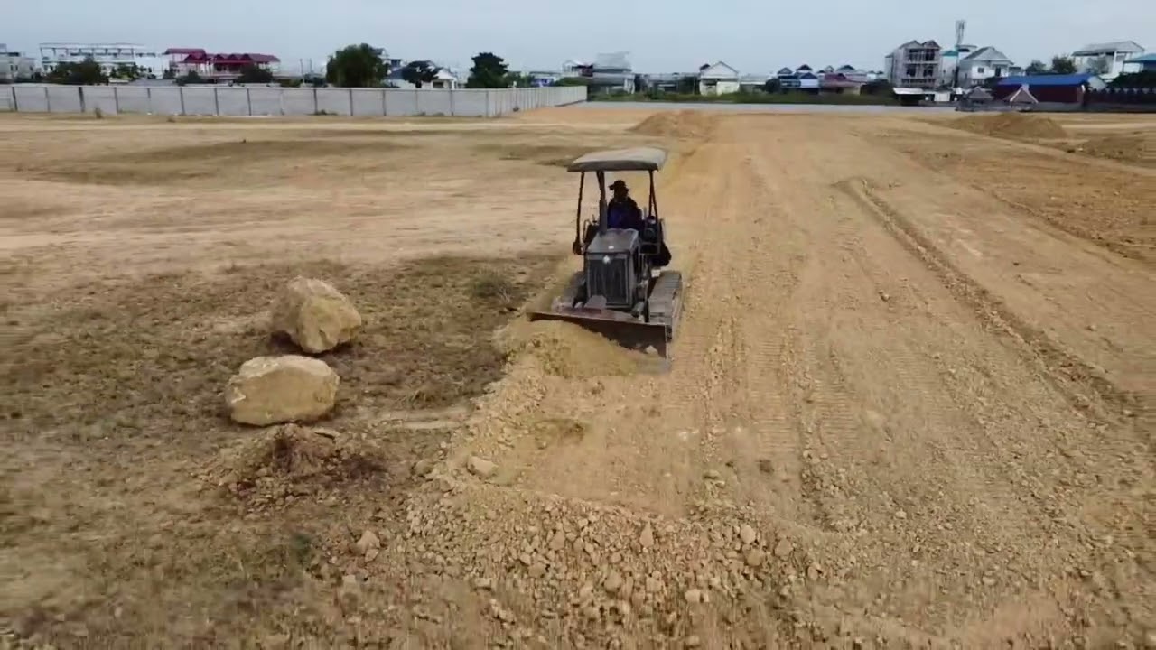 Hard work under the hot sun Level the road and pour concrete Bulldozer Working Super GM 