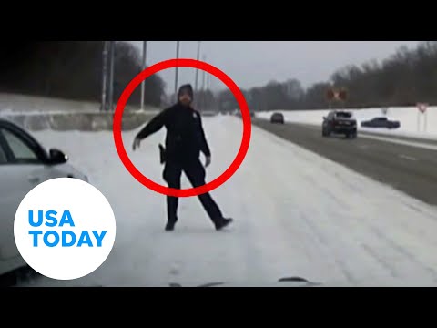 Police officer dodges skidding truck along icy Ohio highway | USA TODAY