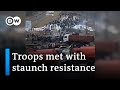 Footage shows how citizens try to stall Russian forces all over Ukraine | DW News