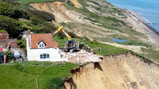 Farmhouse left hanging over perilous cliff edge demolished | SWNS