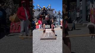 Bodybuilders trying to lift a giant axe in Japan
