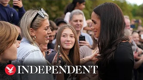 Duchess of Sussex hugs young girl at Windsor castle walkabout