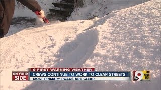 Crews continue to work to clear streets after snow falls across Tri-State on Friday