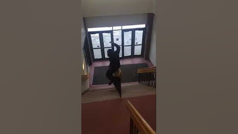 Guy Tries to Slide Down Railing and Faceplants into Door - 1017927