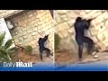 Hamas fighter engages in gun battle with Israeli soldiers as crowd cheer him on