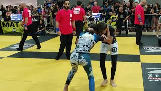 lower grey belt BJJ girl quickly submits orange belted boy with incredible arm bar/triangle choke.