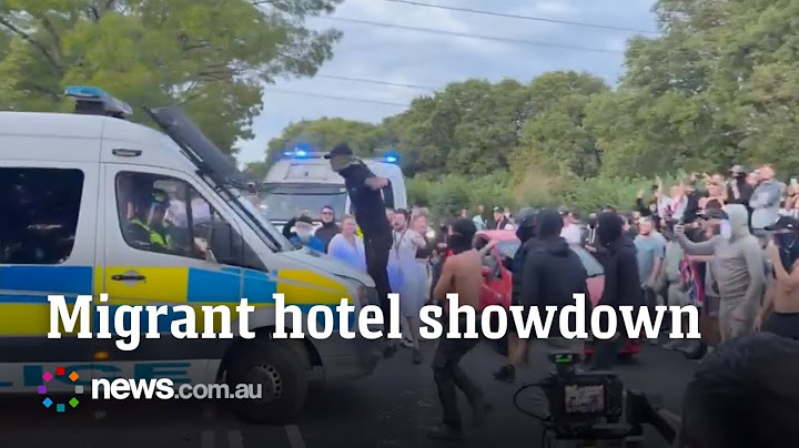 Protesters clash with cops outside migrant hotel after alleged sexual assault