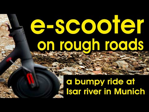 escooter riding in Munich on rough roads along the Isar river