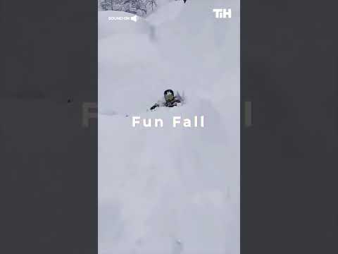 Person Falls Into Snow After Skiing off Incline