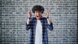 Portrait of angry young girl student screaming standing on brick background