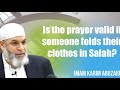 Is the prayer valid if someone folds their clothes in Salah