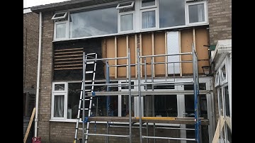 Behind the tiled panel installing insulation and upvc cladding