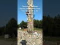 Camino de santiago placing a cross at the cruz de ferro